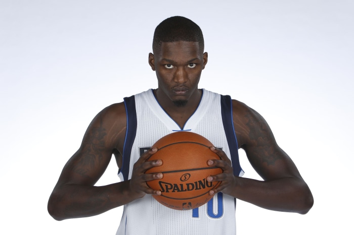 Dorian Finney-Smith holding a Spalding basketball