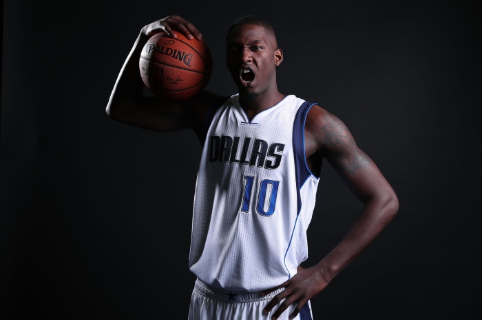 Dorian Finney-Smith holding a Spalding basketball