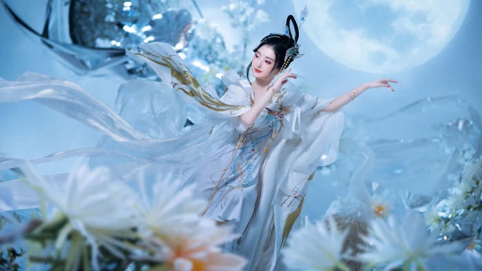 Asian woman in traditional white dress dancing