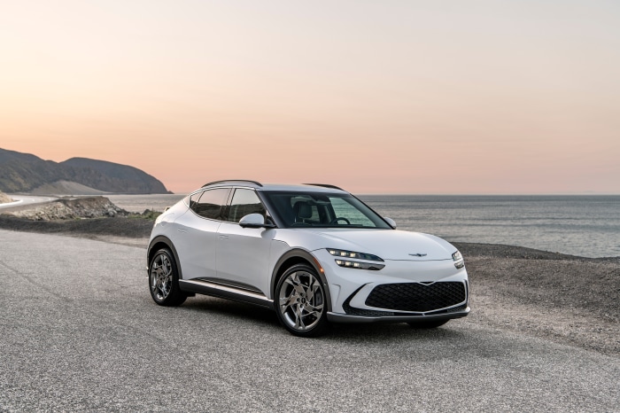 White Genesis GV60 parked on a coastal road