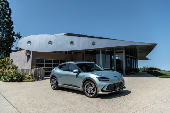 Genesis GV60 in front of a modern building