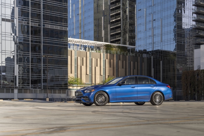 Blue Mercedes-Benz C 300 parked in front of modern buildings