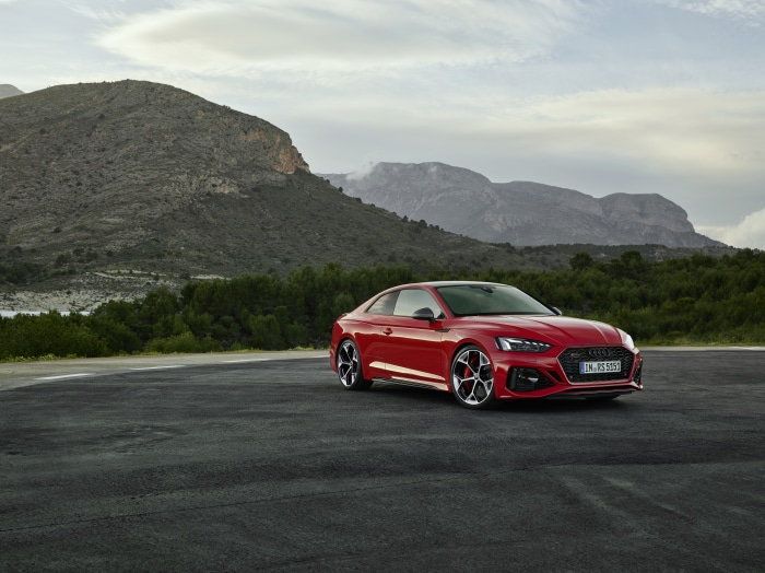 Red Audi RS5 Coupe on a Road with Mountains