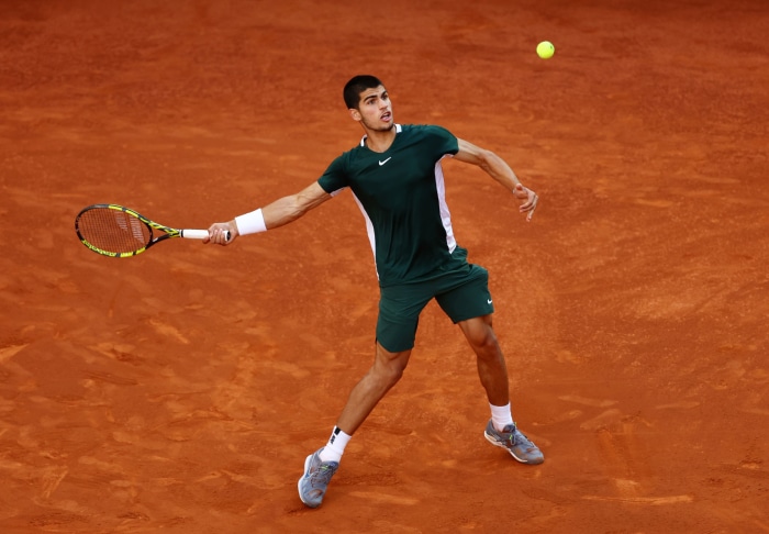 Carlos Alcaraz playing tennis on a clay court