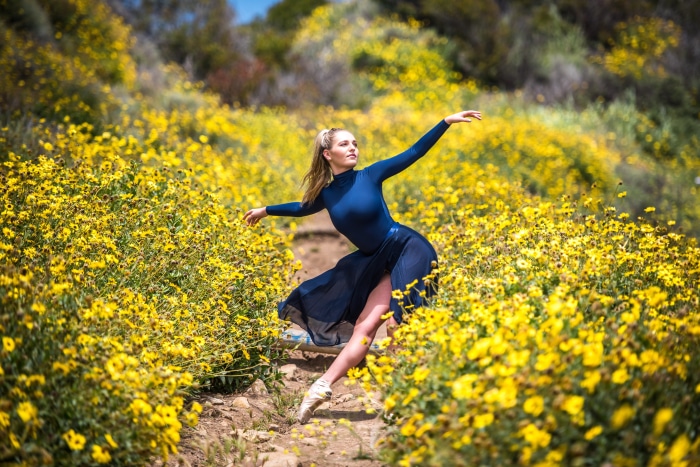 Ballet Dancer Performing Outdoors in Field of Yellow Flowers