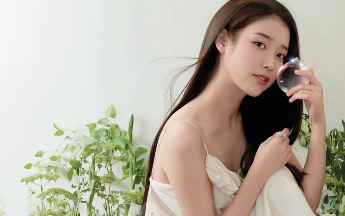 IU holding a water droplet
