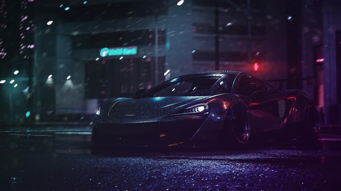 McLaren sports car on a wet city street at night