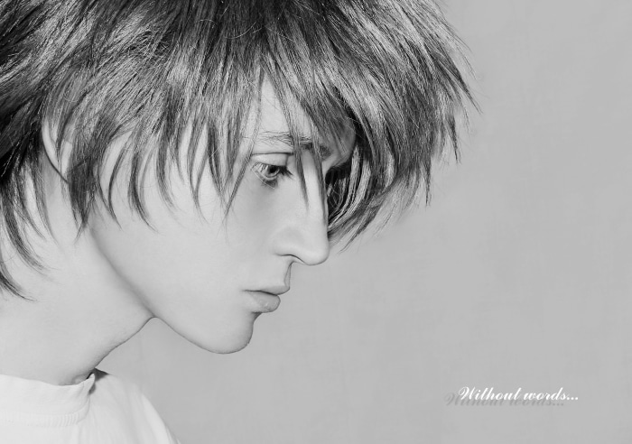 Model with messy hair looking down