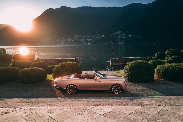 Rolls-Royce Boat Tail convertible by a lake at sunset