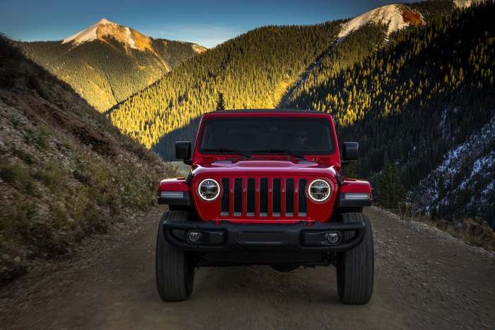 Red Jeep Wrangler on a mountain road