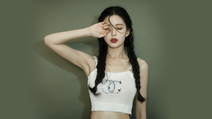 Model with braided hair and Chanel top