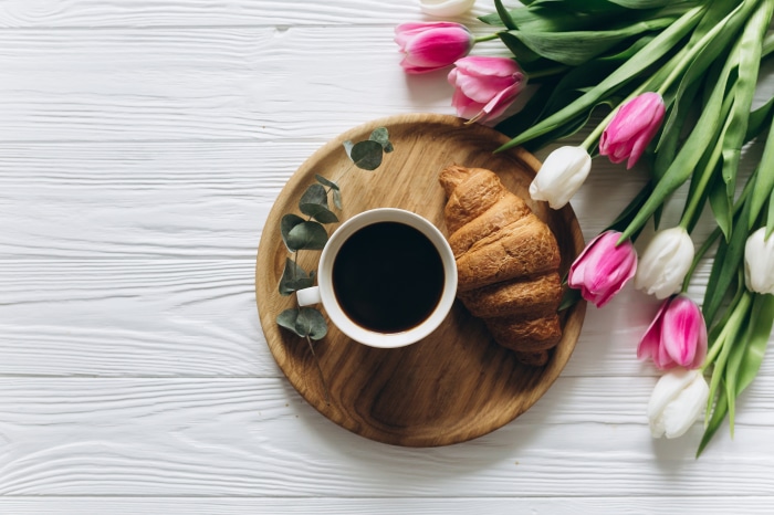 Minimalist breakfast with coffee and tulips