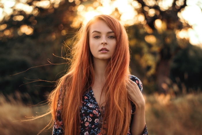 Woman with long red hair in a floral dress