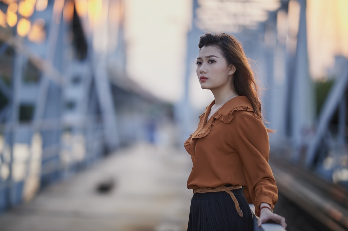 Asian woman on a bridge 4K