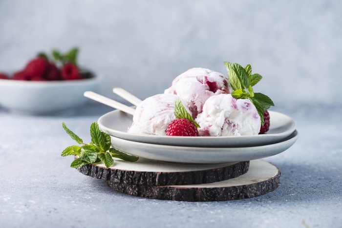 Raspberry ice cream with mint and fresh raspberries