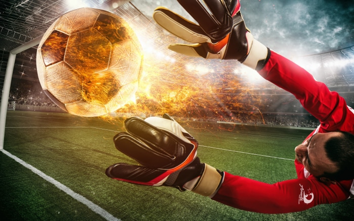 Soccer goalkeeper saving a fiery ball