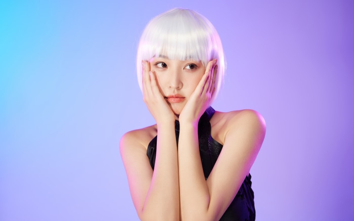 Asian woman with white bob wig and black top