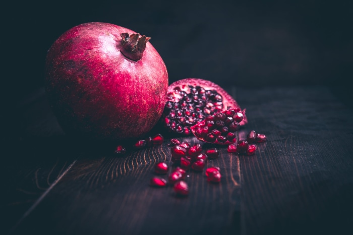 Pomegranate on a dark wooden surface