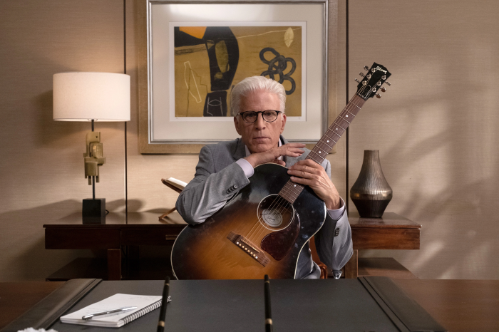 Michael from The Good Place holding a guitar