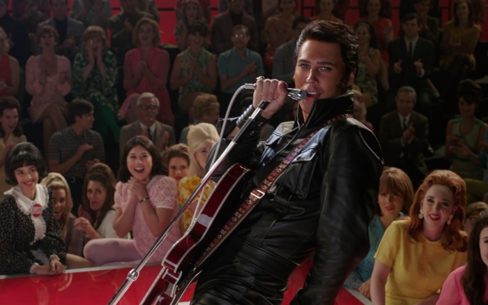 Austin Butler as Elvis Presley performing on stage