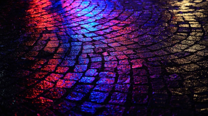 Cobblestone street with red and blue reflections 4K