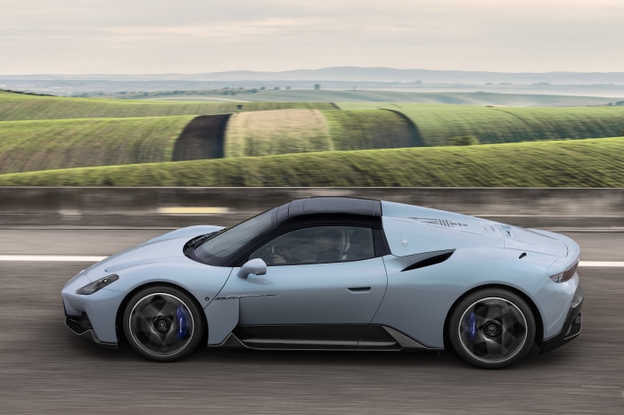 Maserati MC20 Cielo driving on a road with rolling hills