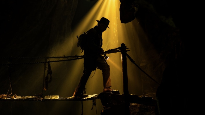 Indiana Jones in a cave with a flashlight
