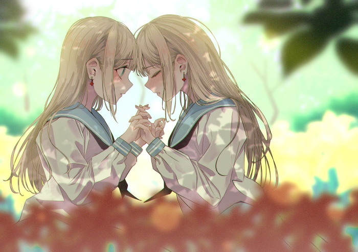 Two girls holding hands in a garden