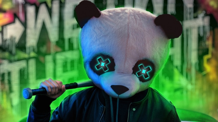 Panda mask person holding baseball bat with graffiti background
