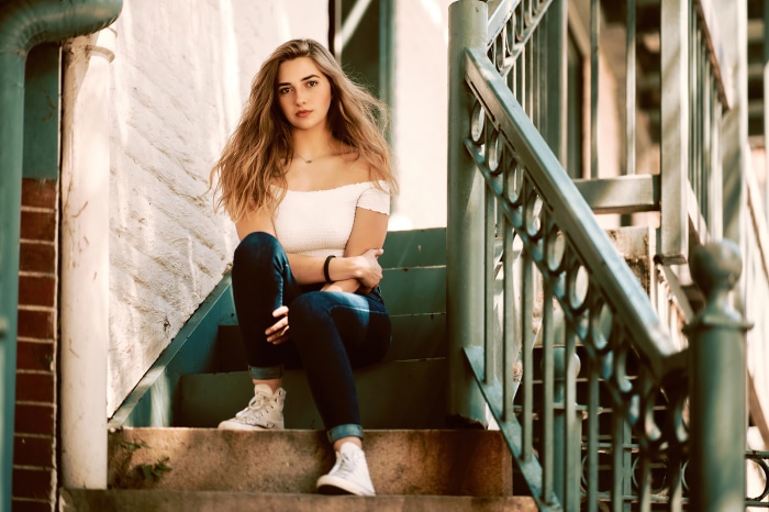 Young woman sitting on stairs