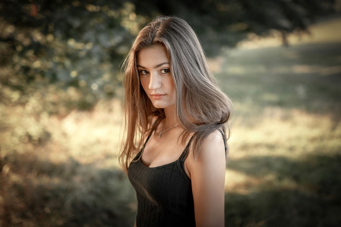 Model in black dress outdoors