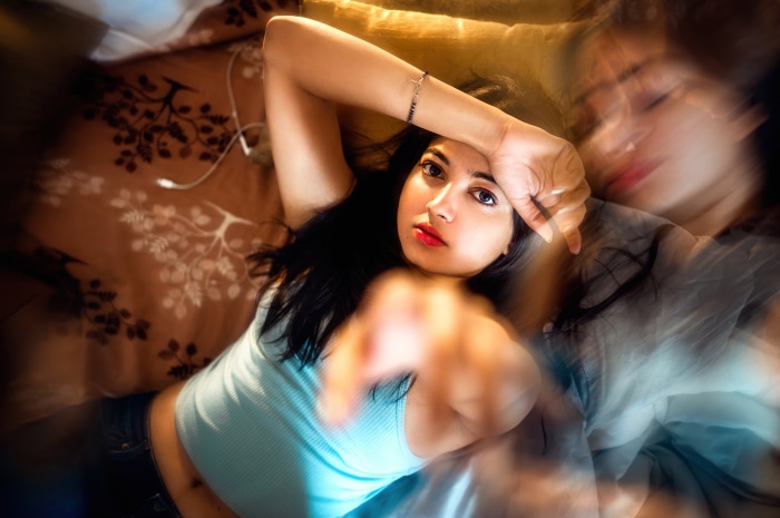 Girl lying on bed with headphones