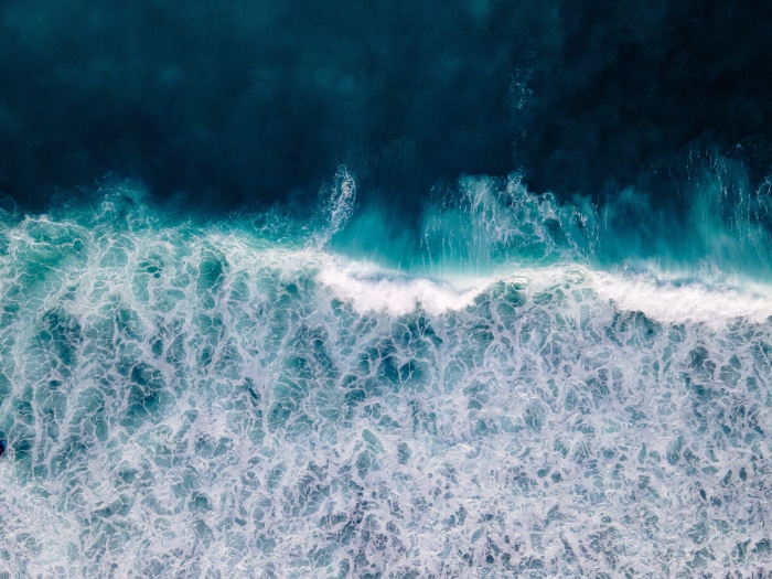 Aerial view of ocean waves crashing
