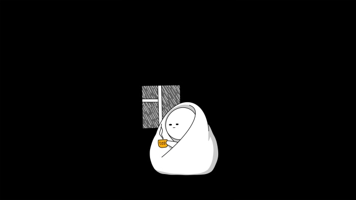 Person wrapped in blanket with tea by window