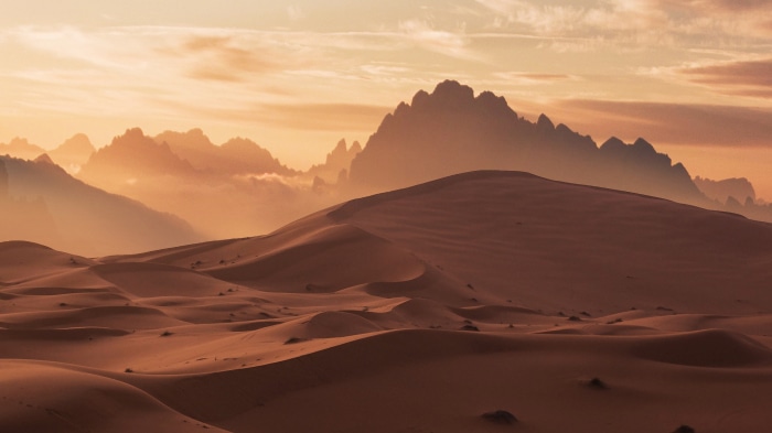 Desert dunes and mountains at sunset 4K