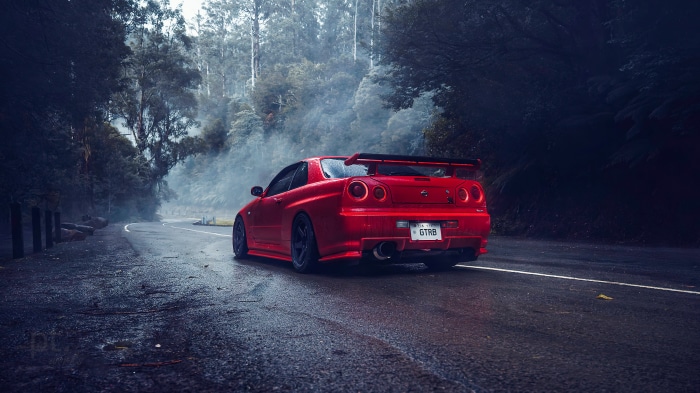 Red Nissan GTR on a Foggy Road