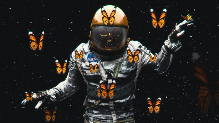 Astronaut surrounded by butterflies in space