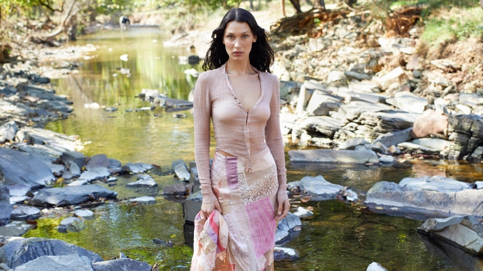 Bella Hadid posing by a stream