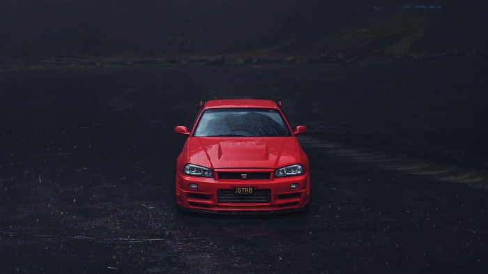 Red Nissan GT-R R34 in the rain