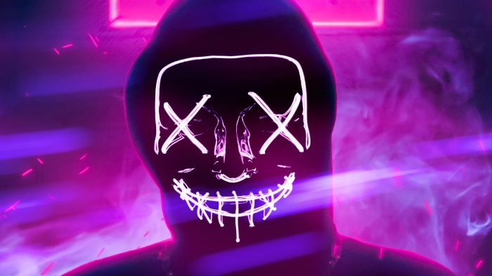 Person in a neon Purge mask with glowing lines