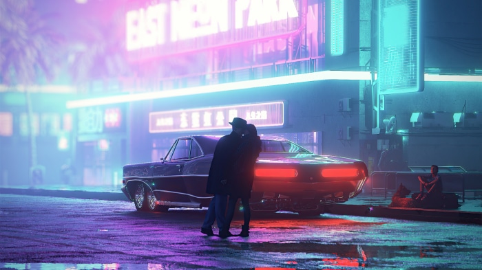 Couple kissing by a classic car in neon city