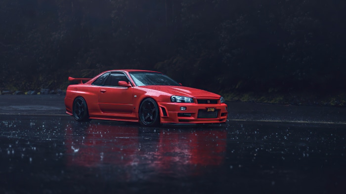 Red Nissan Skyline R34 in the rain