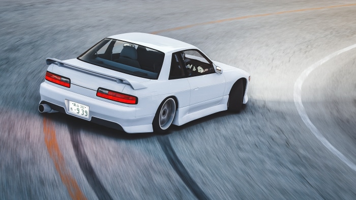White Nissan Silvia S13 drifting on a track