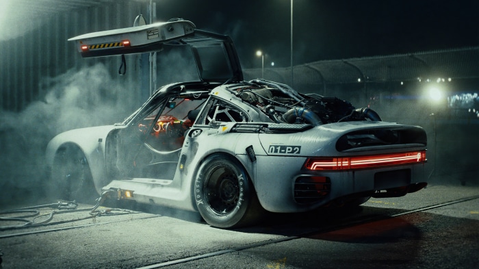Sci-fi Porsche 959 in a dimly lit industrial area