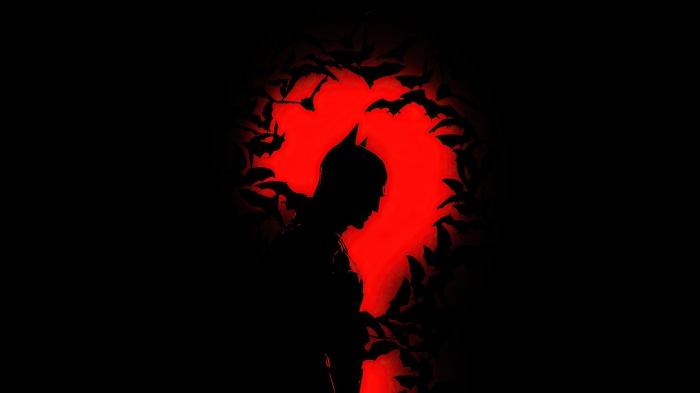 The Batman silhouette with bats and red background