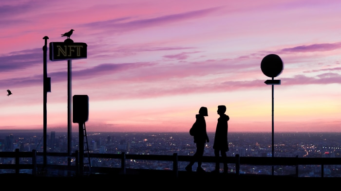 Couple on a rooftop overlooking city at sunset