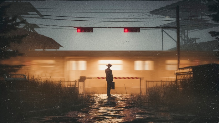 Man in cowboy hat at train crossing