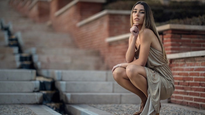 Blonde Model in Elegant Dress Posing on Stairs