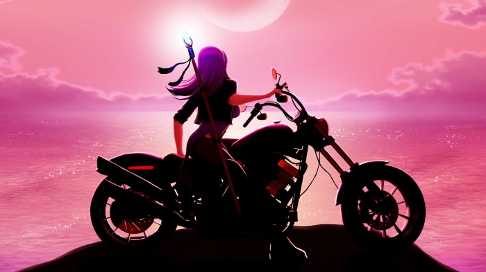 Woman with staff on a motorcycle at sunset
