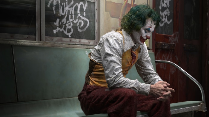 Joker sitting on a subway seat